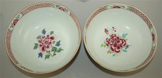 A pair of Chinese famille rose bowls, Qianlong period, 23.3cm, some faults, wood stands